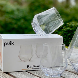Crystal glasses sold by Uniek Living. Modern home accessories on a black tray.