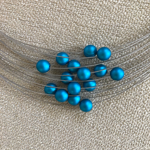 A 15-strand necklace from MOOI. Beautiful blue beeds make it a unique piece of modern jewelry.
