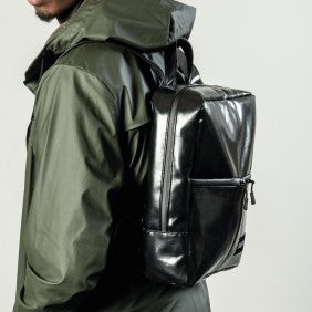 The Alberty Cuyp waterproof backpack in black modeled in black.